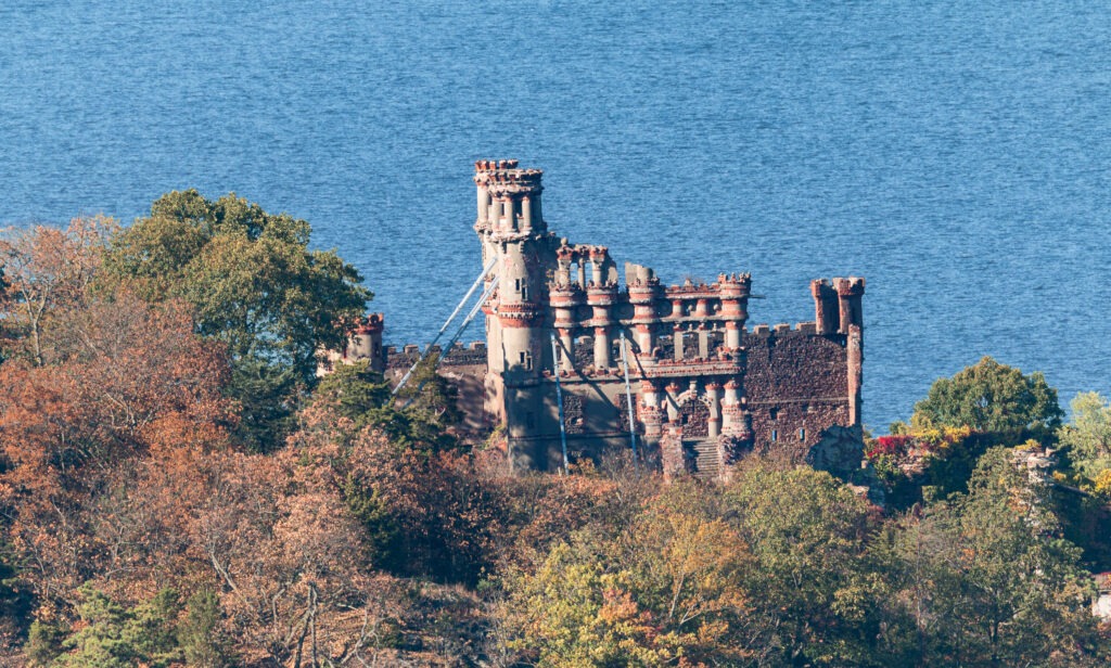 Bannerman Castle on Pollepel Island in the Hudson River, surrounded by autumn foliage.